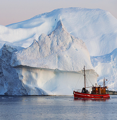 image of fishing boat next to glacier