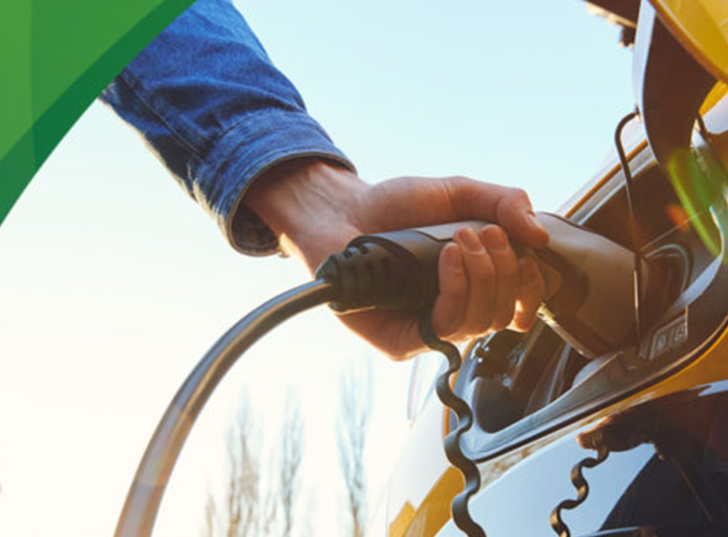 image of man plugging his EV car in