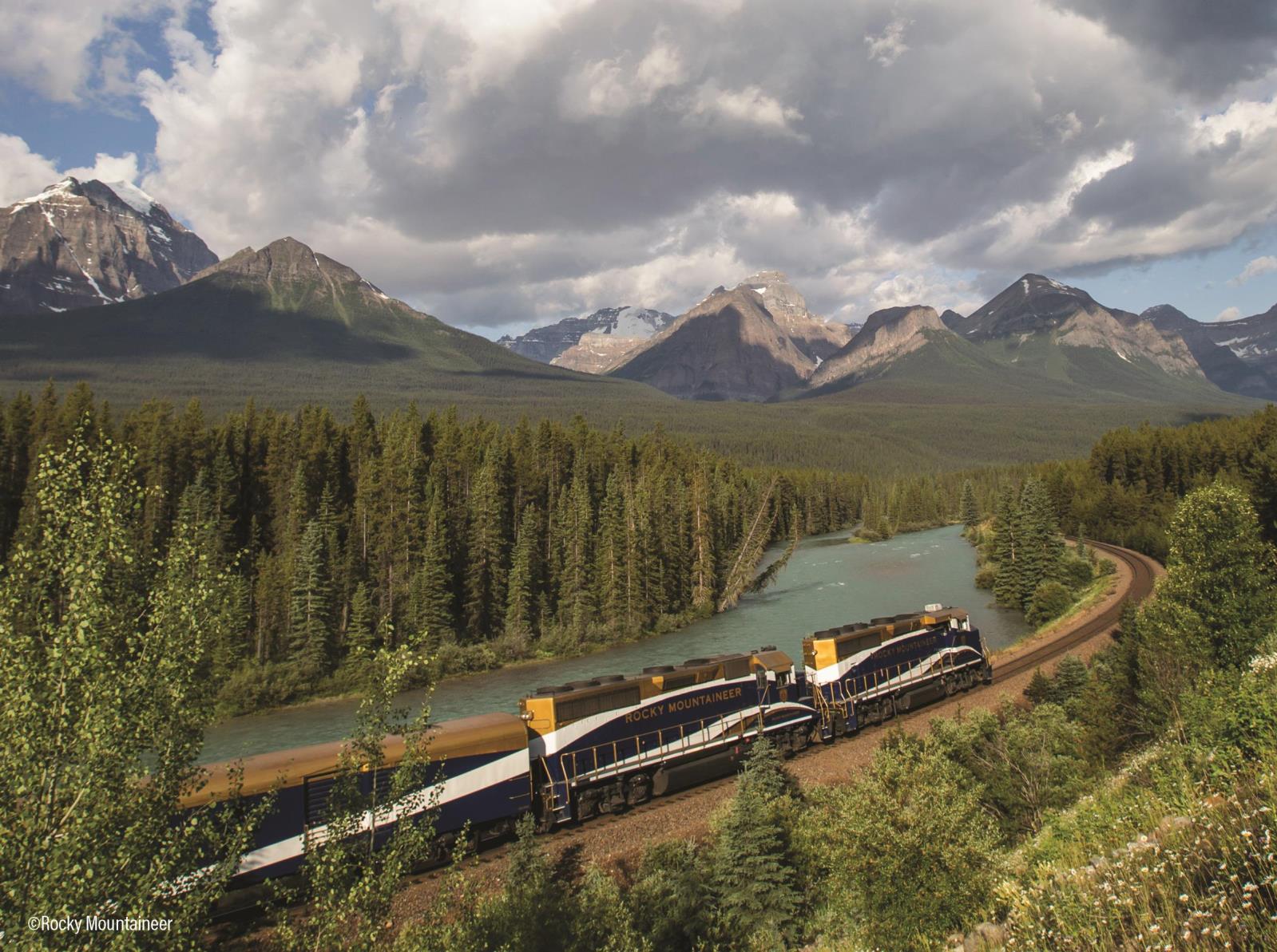 image of train traveling through mountain range