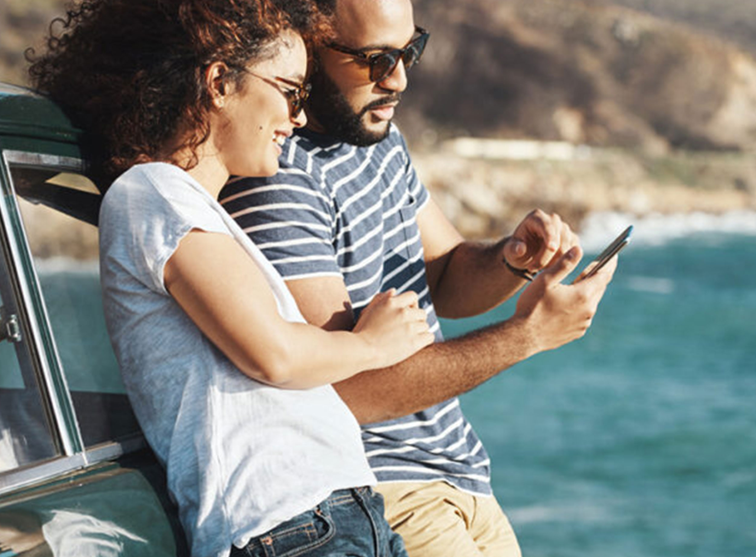 image of man and woman looking at phone on spring break