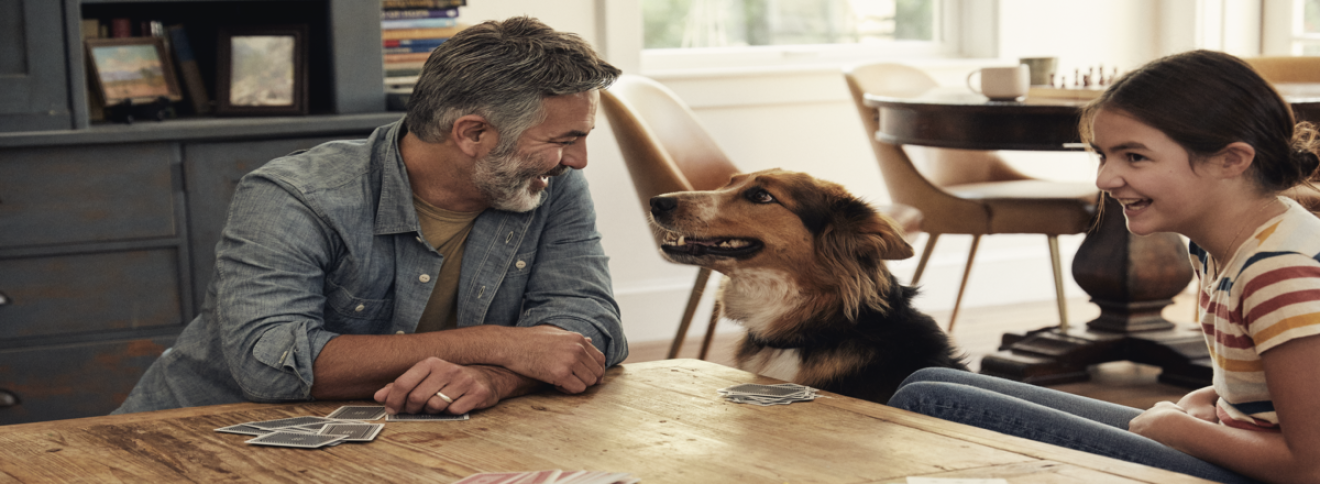 image of a man and a girl smiling at a dog