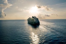 image of cruise ship sailing on the ocean at sunset